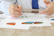 Businessman Analyzing Investment Charts at His Workplace
