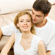 Cheerful smiling young couple, indoors
