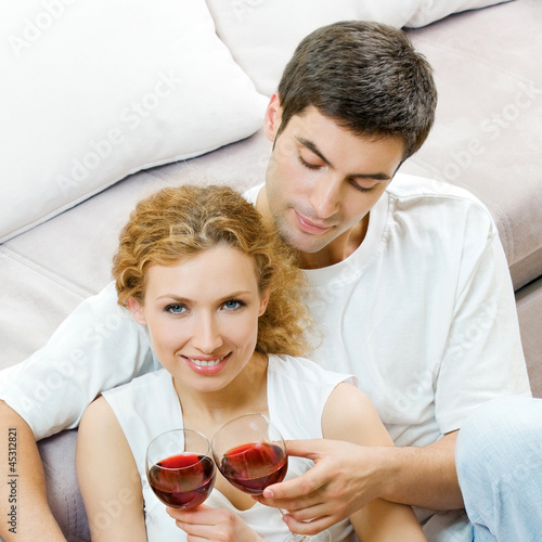 Photo: Cheerful couple with glasses of redwine Cheerful couple with glasses of redwine