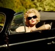 Woman in retro car
