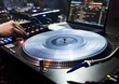 DJ plays set in vinyl player