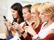 Foto: 3 girls with smartphone on the sofa 3 girls with smartphone on the sofa