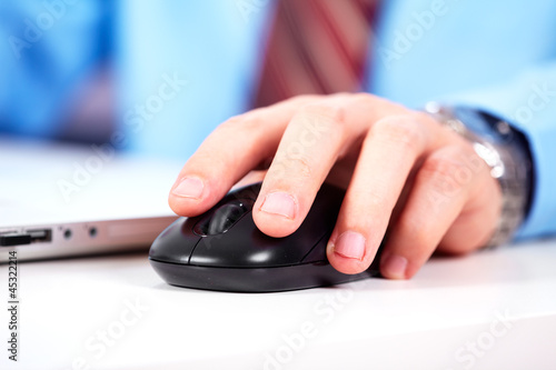Photo: Hand with a computer mouse. Hand with a computer mouse.