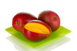 Ripe appetizing mango on green plate isolated on white