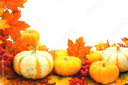Photo: Border or frame of pumpkins and vibrant autumn leaves Border or frame of pumpkins and vibrant autumn leaves
