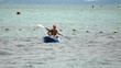 Mother and son kayaking at tropical sea