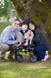 Disabled child surrounded by parents