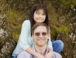 Little girl hugging father around neck