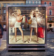 Two shopping women on exhibition window