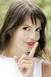 mischievous gril making silence in outdoor scene