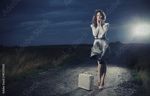 Photo: Retro woman with suitcase Retro woman with suitcase