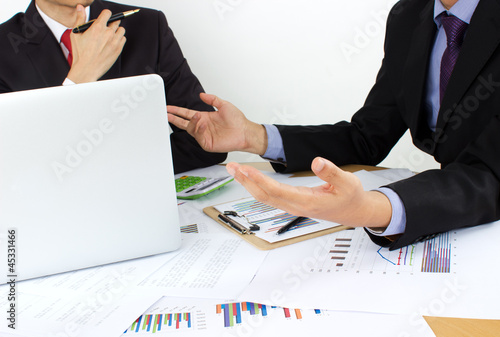 Photo: two business men review the documents two business men review the documents