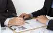 two business men review the documents