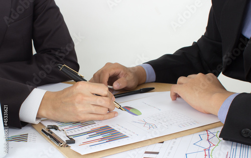 Photo: two business men review the documents two business men review the documents