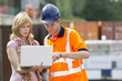 Photo: Businesswoman and worker with laptop Businesswoman and worker with laptop