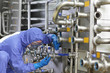 technician fixing valves in plant