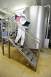 scientist with tablet checking sample in industrial interior