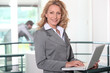 Photo: blonde businesswoman all smiles with laptop blonde businesswoman all smiles with laptop