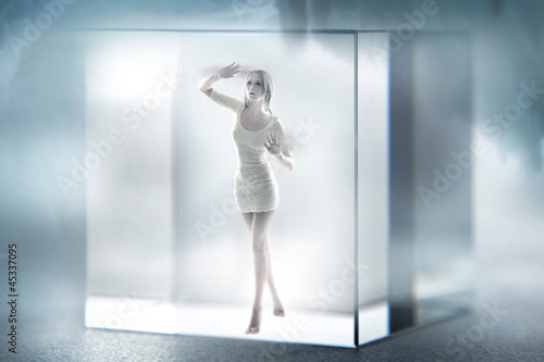 Photo: Cute blond lady imprisoned in a glass cube Cute blond lady imprisoned in a glass cube
