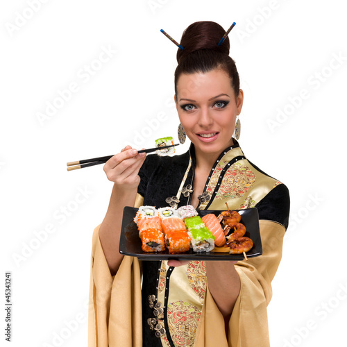 Photo: Woman wearing a traditional dress eating sushi Woman wearing a traditional dress eating sushi