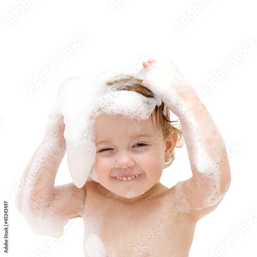 Photo: baby girl with soap suds on hair taking bath. baby girl with soap suds on hair taking bath.