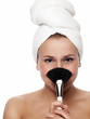 Face of beautiful women with make-up brush - isolated