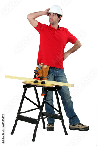 Photo: carpenter with workbench looking puzzled carpenter with workbench looking puzzled