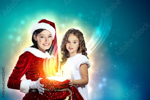 Photo: Little girl with christmas gifts and santa Little girl with christmas gifts and santa