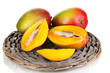 Ripe appetizing mango on wicker cradle isolated on white