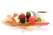 delicious sushi served on wooden board isolated on white