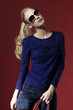 Portrait of pretty young fashion model posing wearing sunglasses