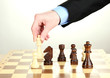 businessman playing chess isolated on white.