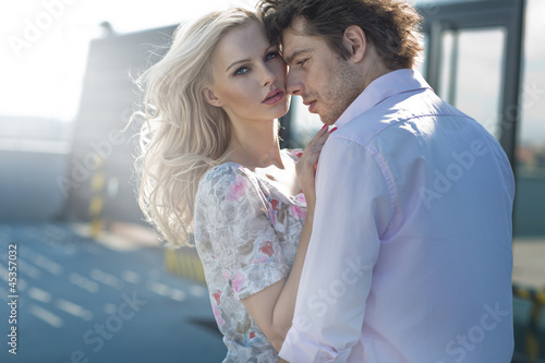 Photo: Young couple posing in urban scenery Young couple posing in urban scenery