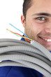 Tradesman carrying corrugated tubing