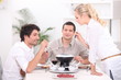 Three people enjoying fondue