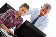 Concerned office couple at a computer
