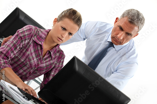 Photo: Concerned office couple at a computer Concerned office couple at a computer