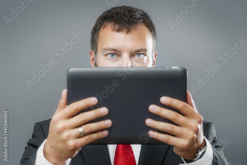 Photo: business man reading tablet pc business man reading tablet pc