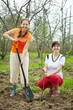 Happy women planting fruit tree