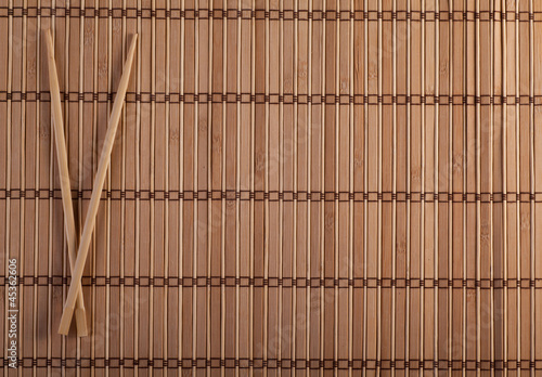 Photo: Two chopsticks on sushi background Two chopsticks on sushi background