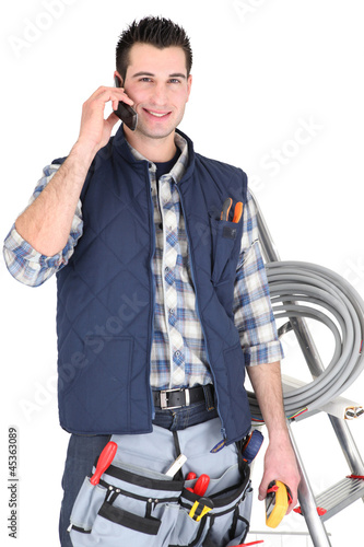 Photo: Electrician making call to supplier Electrician making call to supplier