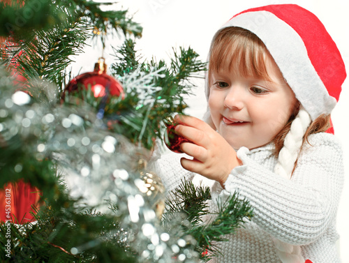 Photo: beautiful girl on a background of the Christmas tree beautiful girl on a background of the Christmas tree