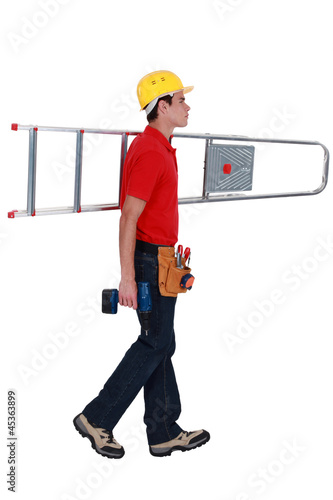 Photo: carpenter carrying ladder isolated on white carpenter carrying ladder isolated on white