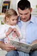 Father reading a story to his daughter