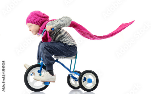 Photo: Little girl rides a bicycle on white background Little girl rides a bicycle on white background