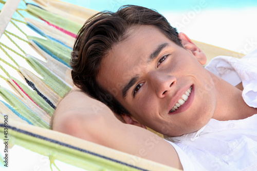 Photo: Man laying in hammock Man laying in hammock
