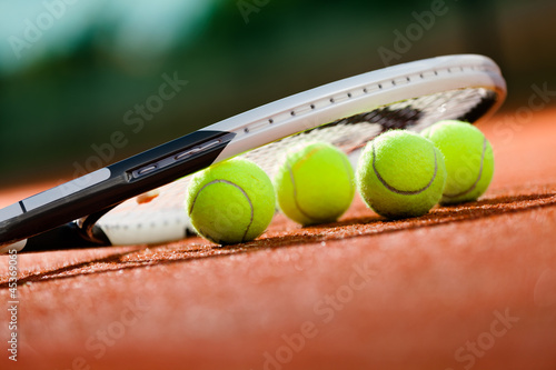 Photo: Close up view of tennis racket and balls Close up view of tennis racket and balls