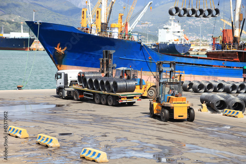 Photo: truck in harbor with ship in background truck in harbor with ship in background