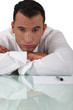bored businessman sitting at his desk