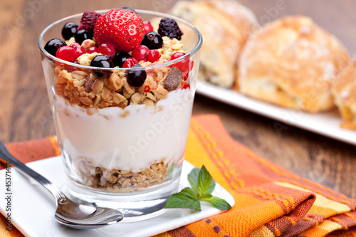 Photo: yogurt with muesli and berries in small glass yogurt with muesli and berries in small glass